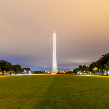 USA, Washington DC, Cloudy sky over lawn in front of Washington Monument at dusk