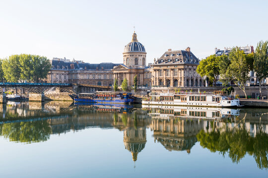 France, Ile-de-France, Paris, Institut de France reflecting in river Seine
