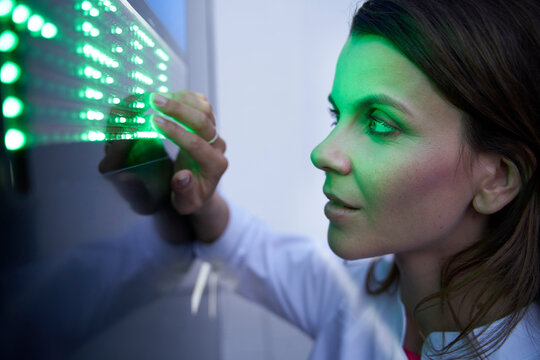 Close-up of woman touching green led touchscreen