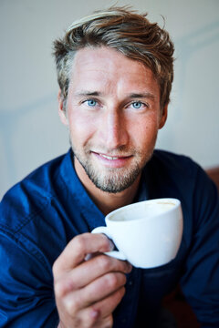 Portrait Of Young Man Holding Cup Of Coffee