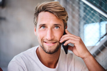 Portrait of young man wearing t-shirt talking on the phone