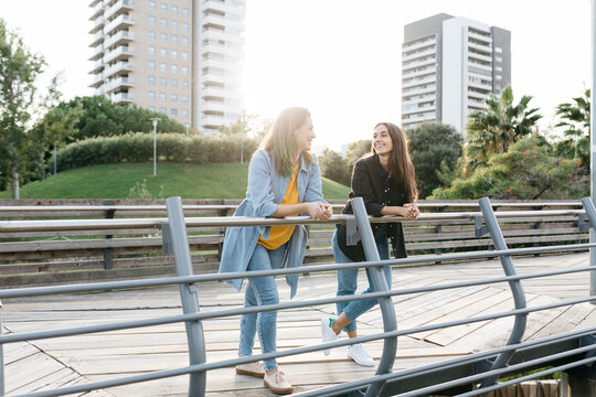 Two friends in a park talking and enjoying their free time