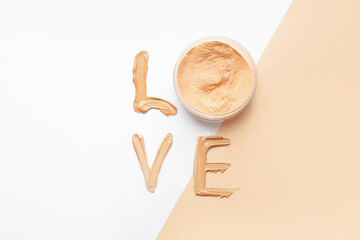 Word LOVE made of makeup foundation and face powder on color background
