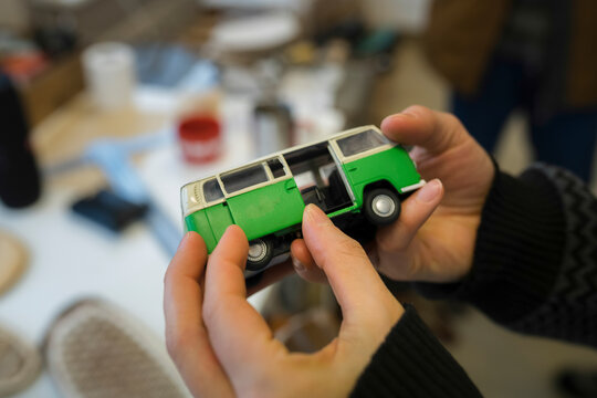Close-up of woman holding minibus model