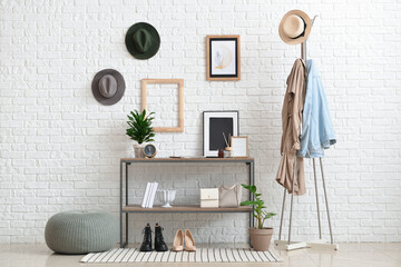 Interior of stylish hallway with modern shelves and rug