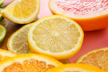 Slices of citrus fruits on color background, closeup