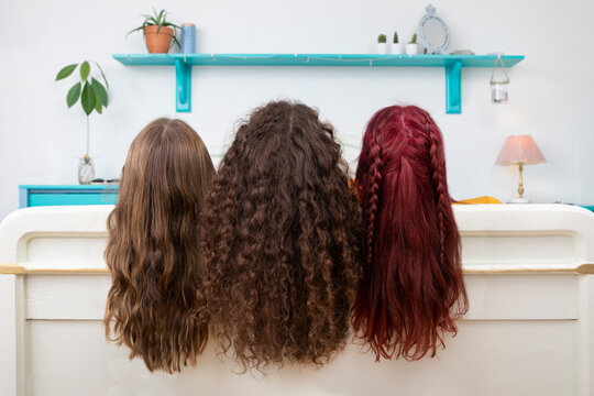 Back view of three sisters with long hair