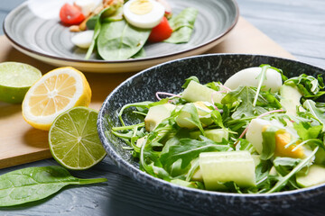 Plate with healthy salad on color wooden background