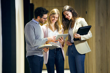 Three confident business people meeting on office floor