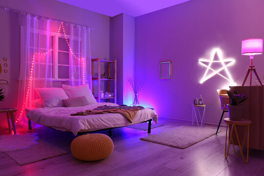 Interior Of Stylish Bedroom With Neon Lighting