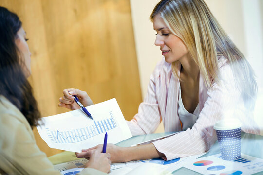 Businesswoman having a meeting with colleague sharing graphs