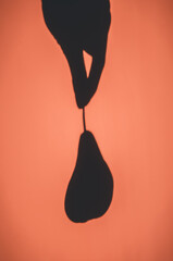Shadow on the wall from a hanging pear. Background