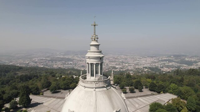Sanctuary of Our Lady of Sameiro overlooking Braga. Cross and church tower details. Orbiting shot 