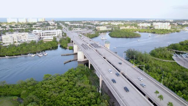 Aerial drone view overlooking traffic on a highway bridge in Jupiter, Florida