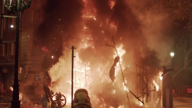 The final night of las fallas in valencia, Spain. Ninot dolls are burning on the streets, clouds of smoke and fire are rising high up.