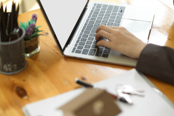 Fototapeta na wymiar Business women's hand typing on laptop keyboard. woman working from home