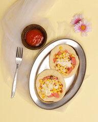 Mini pizza with corn, sausage and cheese topping for your lunch menu. pizza is a savory dish from Italy a kind of round and flat dough, baked in the oven. Pizza mockups. Focus blur. Focus on some ange