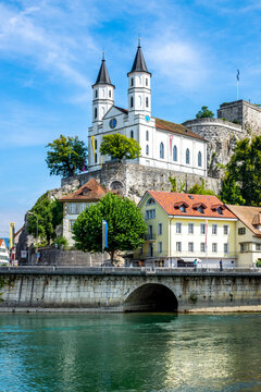 Church and fortress by Aare River in Aarburg against sky