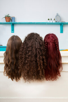 Back view of three sisters with long hair