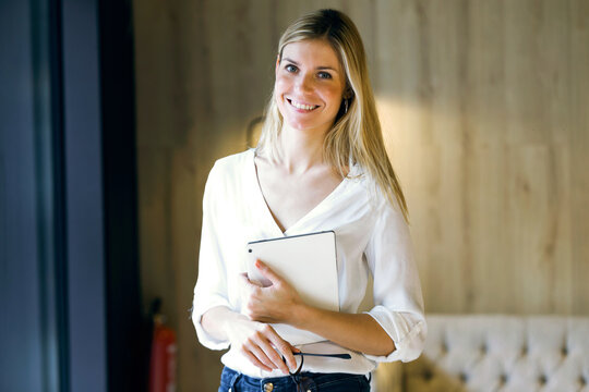 Portrait of smiling businesswoman holding tablet