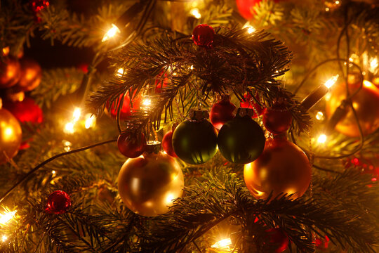 Christmas tree with Christmas baubles and light chains, partial view