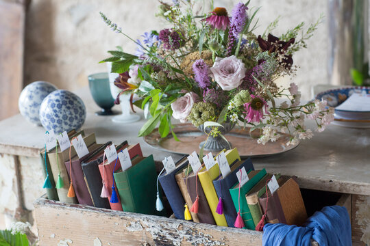 Decoration of multi colored flower and books on wedding table
