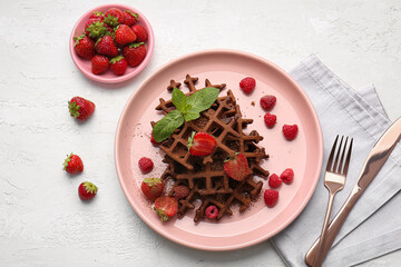 Plate of delicious Chocolate Belgian Waffles with berries on white background
