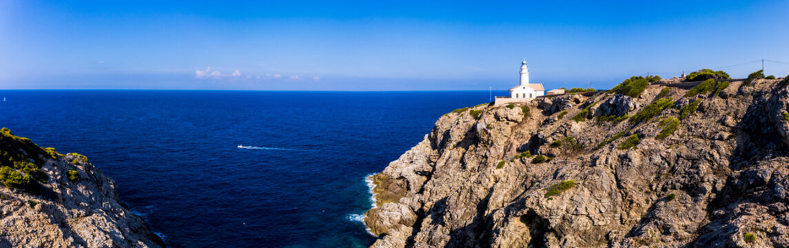 Spain, Mallorca, Cala Ratjada, Helicopter view of Far de Capdepera lighthouse in summer