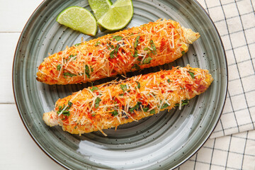 Plate with tasty Elote Mexican Street Corn on white wooden background