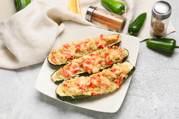 Composition with quinoa stuffed zucchini boats on light background