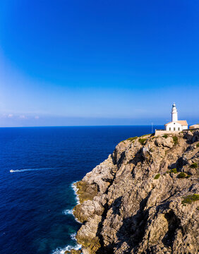 Spain, Mallorca, Cala Ratjada, Helicopter view of Far de Capdepera lighthouse in summer