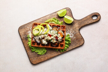 Tasty Belgian waffle with vegetables and lime on light background
