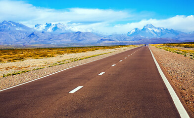Highway leading to mountains of Andes, near Las Lenas. Argentina, South America.