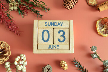 June 3, Cover design with calendar cube, pine cones and dried fruit in the natural concept.
