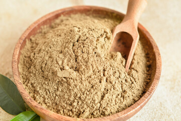 Bowl of hojicha powder on light background, closeup