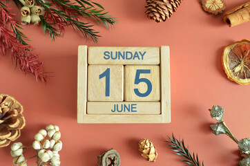 June 15, Cover design with calendar cube, pine cones and dried fruit in the natural concept.