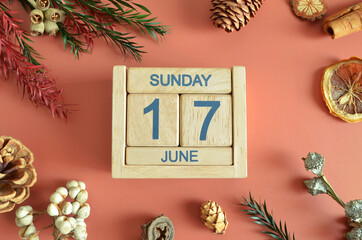 June 17, Cover design with calendar cube, pine cones and dried fruit in the natural concept.