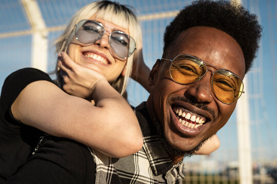 Portrait of laughing young man having fun with his girlfriend