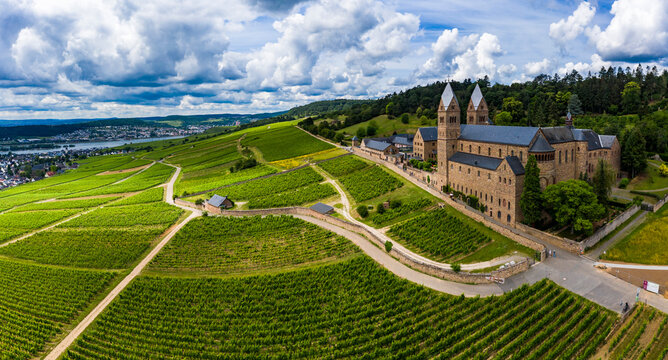 Germany, Hesse, Eibingen, Helicopter panorama of vineyards in front of Eibingen Abbey in early autumn