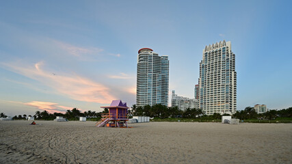 Fototapeta premium Residential towers on Miami Beach, Florida with colorful lifeguard station in foreground.