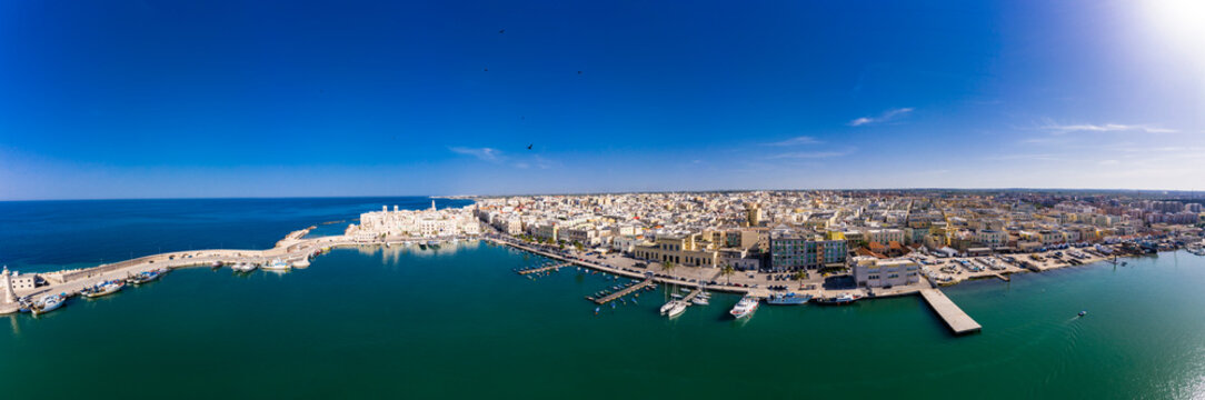 Italy, Province of Bari, Molfetta, Drone panorama of coastal town in summer
