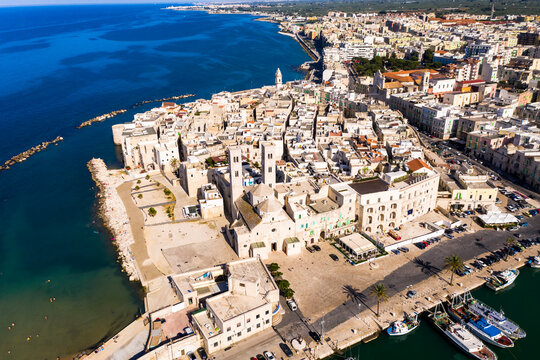 Italy, Province of Bari, Molfetta, Drone view of Church of Saint Conrad and surrounding houses in summer