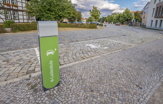 Germany, Saxony-Anhalt, Quedlinburg, Electric car charging station on cobblestone street