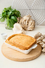 Baking dish with tasty mushroom pot pie on table
