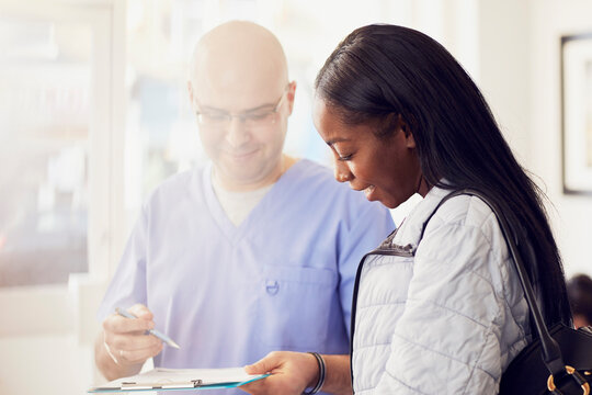 Dentist and patient with document in a dental practice