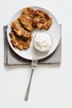 Studio shot of rye and turnip pancakes with sour cream-yogurt dipping sauce