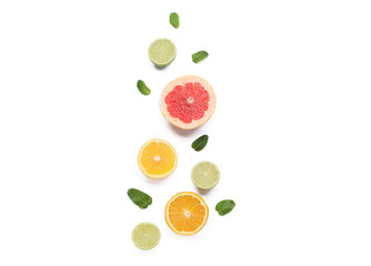 Composition with citrus fruits and mint leaves on white background