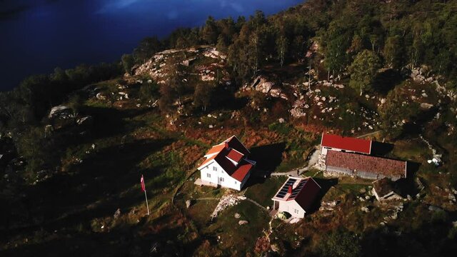 Beautiful DNT-Cabin next to a stunning norwegian Fjpod, 4K aerial shot