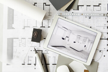 ArchitecturalÔøΩblueprints and digital tablet displaying modern showcase interior