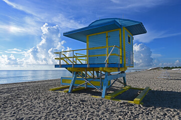 Colorful lifeguard station on Miami Beach, Florida under late summer cloudscape in early morning...